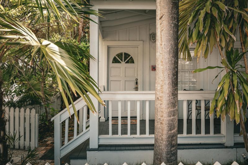 Blog 4 Charming tropical front porch with palm trees and white wood
